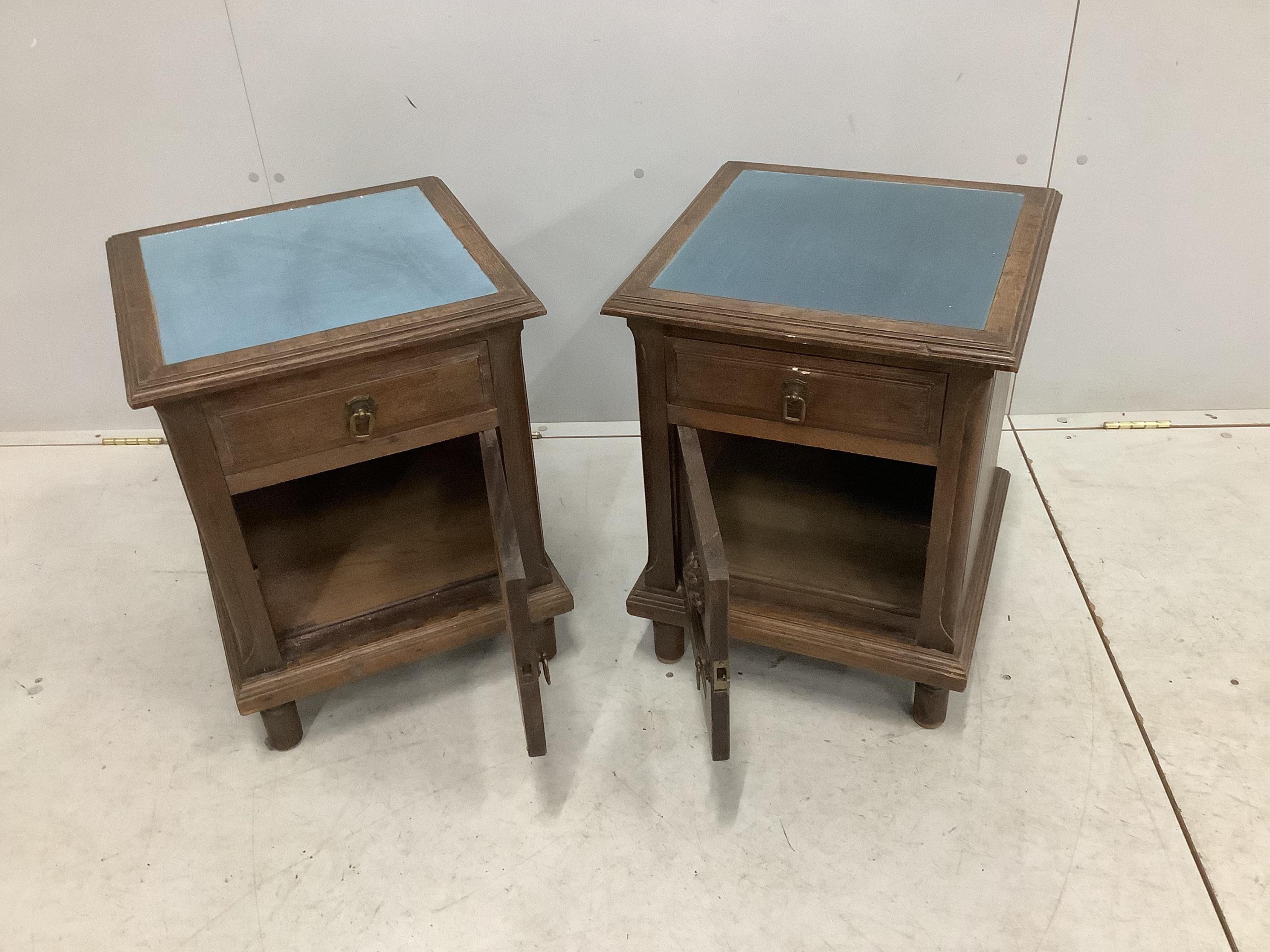 A pair of early 20th century French oak bedside cabinets, width 43cm, depth 42cm, height 55cm. Condition - fair